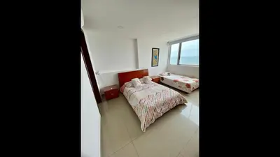 a bedroom with two beds and a window at 2 Bedroom Beachfront Apartment 2P1-Al4 With Pool And WIFI in Cartagena de Indias