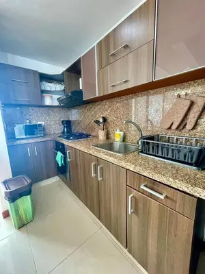 a kitchen with wooden cabinets and a sink at 2 Bedroom Beachfront Apartment 2P1-Al With Pool And WIFI in Cartagena de Indias
