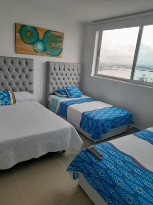 a bedroom with two beds and a window at 2 Bedroom Beachfront Apartment in Cartagena de Indias