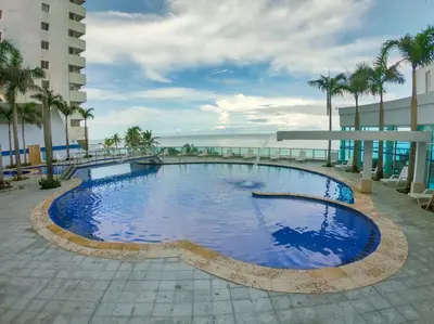 a large swimming pool on the side of a building at 2 Bedroom Beachfront Apartment in Cartagena de Indias
