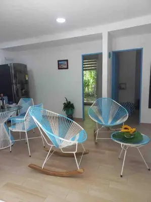 a room with three chairs and a table with a plate on it at Linda cabaña en Isla Tierra Bomba frente a Cartagena in Cartagena de Indias