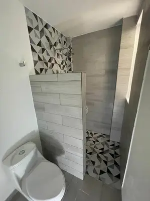 a bathroom with a white toilet and a shower at Linda cabaña en Isla Tierra Bomba frente a Cartagena in Cartagena de Indias