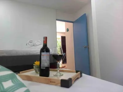 a bottle of wine and a glass on a table at Linda cabaña en Isla Tierra Bomba frente a Cartagena in Cartagena de Indias