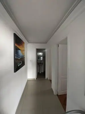 a hallway with white walls and a painting on a wall at Apartamento Amoblado Cartagena in Cartagena de Indias
