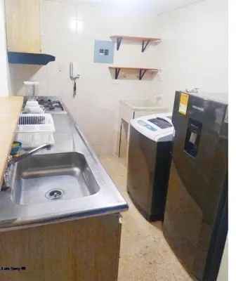a small kitchen with a sink and a refrigerator at Apartamento con Vista al MAR 11 in Cartagena de Indias