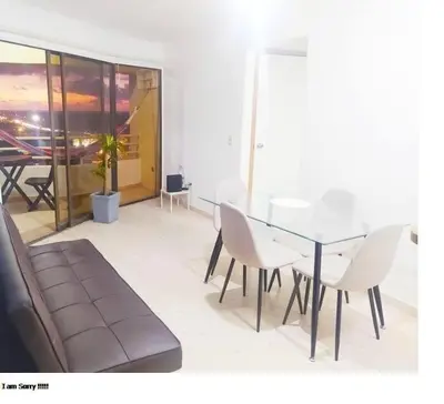 a dining room with a glass table and white chairs at Apartamento con Vista al MAR 11 in Cartagena de Indias