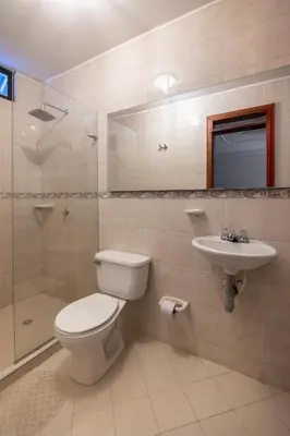 a bathroom with a toilet and a sink and a shower at Hotel Boutique Casa Pere in Cartagena de Indias