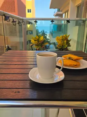 a cup of coffee and a plate of food on a table at Cartagena Apartamento 409 Edf Morros 922 ToLuSa in Cartagena de Indias