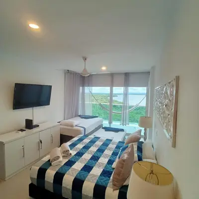 a hotel room with a bed and a television at Apartamento Morros 922 in Cartagena de Indias