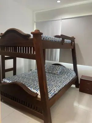 a wooden bunk bed in a room at DISFRUTE Y PLAYA in Cartagena de Indias