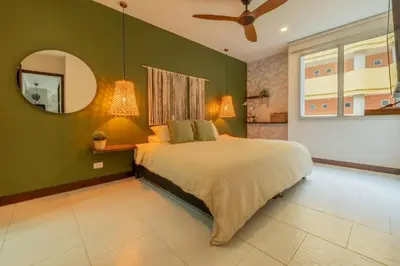 a bedroom with a large bed and a mirror at Condominio frente al mar con acceso directo a la playa Morros 922 in Cartagena de Indias