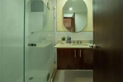 a bathroom with a shower and a sink and a mirror at Condominio frente al mar con acceso directo a la playa Morros 922 in Cartagena de Indias