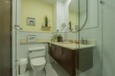 a bathroom with a toilet and a sink and a mirror at Condominio frente al mar con acceso directo a la playa Morros 922 in Cartagena de Indias