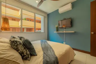 a bedroom with a bed and a flat screen tv at Condominio frente al mar con acceso directo a la playa Morros 922 in Cartagena de Indias