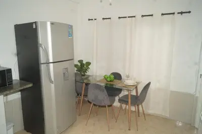 a kitchen with a refrigerator and a table with chairs at Apartamento el Calamar in Cartagena de Indias
