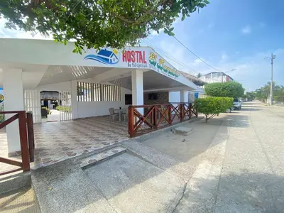 a fast food building with a sign on it at Hostal El Danubio Tolu in Tolú