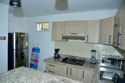 a kitchen with a stove and a refrigerator at Edificio Cristoforo Colombo Apartamento in Cartagena de Indias