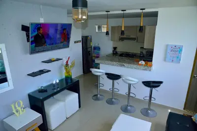 a kitchen with stools and a counter in a room at Edificio Cristoforo Colombo Apartamento in Cartagena de Indias