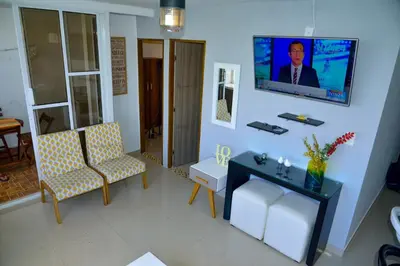 a living room with a flat screen tv on a wall at Edificio Cristoforo Colombo Apartamento in Cartagena de Indias