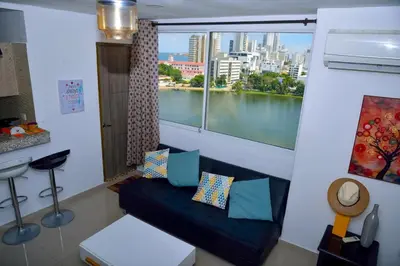 a room with a couch and a window with a view at Edificio Cristoforo Colombo Apartamento in Cartagena de Indias