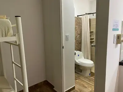 a bathroom with a white toilet and a shower at Casa ISABELLA - Playa dormida in Santa Marta