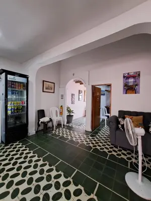 a living room with a couch and a table and chairs at Hostal Casa Lara in Cartagena de Indias