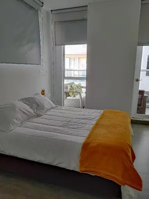 a bedroom with a large bed with a window at Apartamento morros con acceso directo a la playa in Cartagena de Indias
