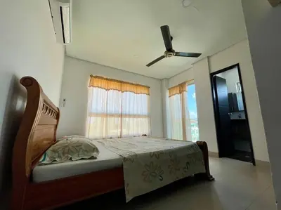 a bedroom with a bed and a ceiling fan at Apartamento en Coveñas cerca al mar #204 in Coveñas