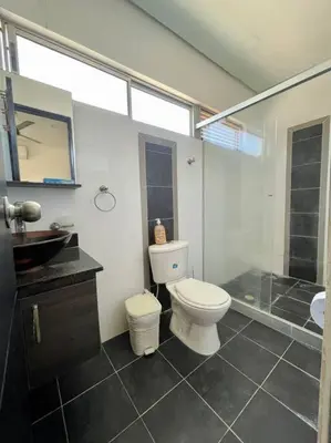 a bathroom with a toilet and a glass shower at Apartamento en Coveñas cerca al mar #204 in Coveñas