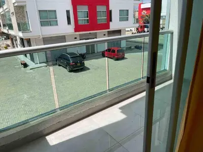 a window with two cars parked in a parking lot at Apartamento en Coveñas cerca al mar #204 in Coveñas