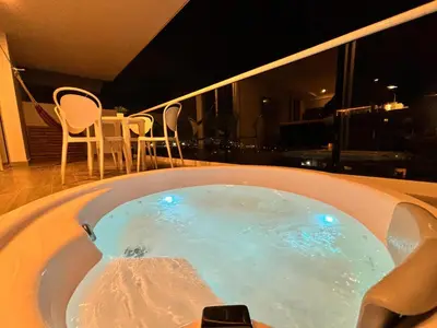 a jacuzzi tub with blue lights in a room at Dominiqueplayaazul apto de lujo con Jacuzzi privado en balcon in Cartagena de Indias
