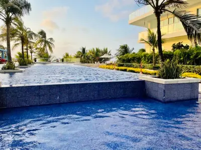 a swimming pool with blue water in front of a building at Cartagena- Apto con acceso y vista al mar Morros Ultra in Cartagena de Indias
