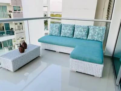 a balcony with a bench and pillows on a building at Cartagena- Apto con acceso y vista al mar Morros Ultra in Cartagena de Indias