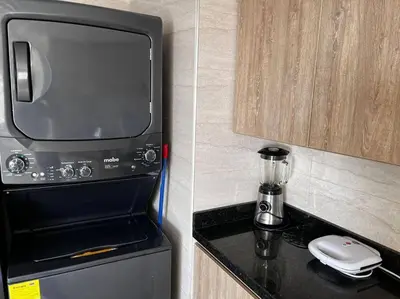 a kitchen with a microwave and a coffee maker on a counter at Vista a la Playa del Cabrero in Cartagena de Indias