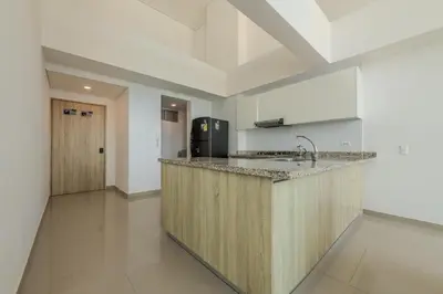 a kitchen with a counter with a sink and a refrigerator at amor por cartagena in Cartagena de Indias