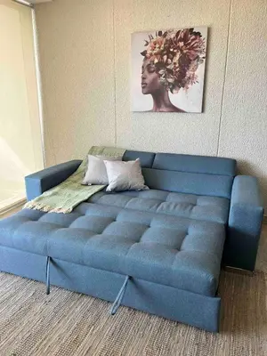 a blue couch in the corner of a room at DQ505 Nuevo hermoso jacuzzi priv in Cartagena de Indias