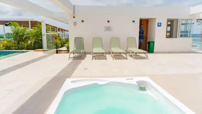 a swimming pool with chairs and a hot tub at DQ505 Nuevo hermoso jacuzzi priv in Cartagena de Indias