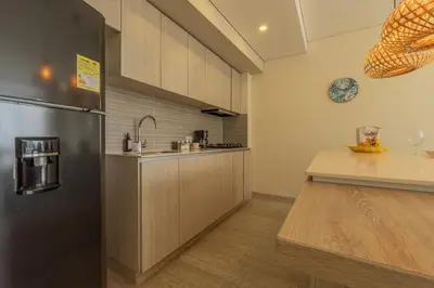 a kitchen with a stainless steel refrigerator and a counter at MQ1003 | Jacuzzi privado · Relax en Cielo Mar in Cartagena de Indias