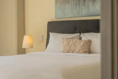 a bed with white sheets and pillows in a bedroom at MQ1003 | Jacuzzi privado · Relax en Cielo Mar in Cartagena de Indias