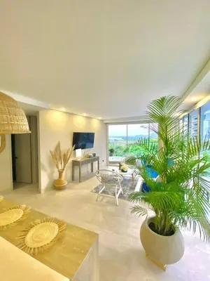 a living room with a potted plant and a television at MQ701 Nuevo Apto Boho Style Jacuzzi privado in Cartagena de Indias