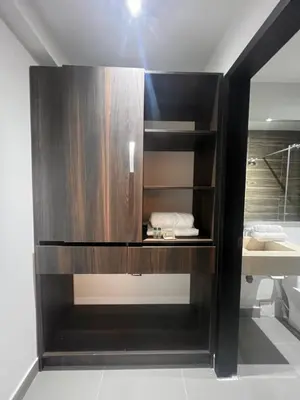 a dark wooden cabinet in a bathroom with a sink at Hotel Zuriel Boutique in Cartagena de Indias