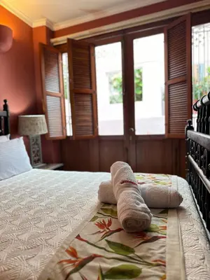 a hotel room with a bed with towels on it at Hotel Boutique Casa Córdoba Estrella in Cartagena de Indias