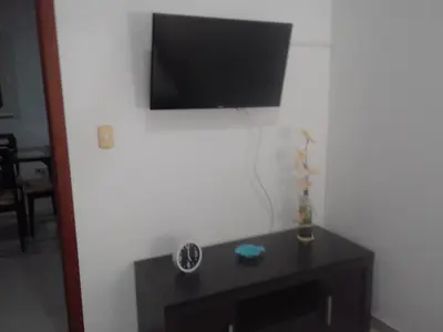 a black table with a television on a white wall at Costa Azul Suites 63 in Playa Dormida