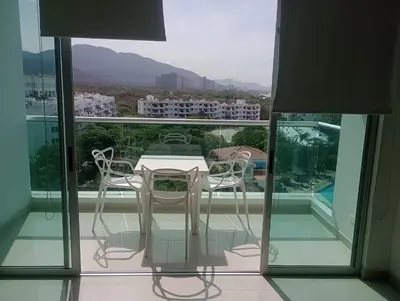a table and chairs on a balcony with a view at Costa Azul Suites 63 in Playa Dormida