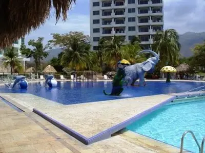 a person standing in the middle of a swimming pool at Costa Azul Suites 63 in Playa Dormida