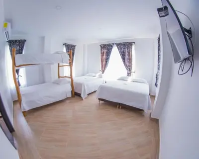 a room with two bunk beds and a window at Beach cabin near Barranquilla in Santa Veronica