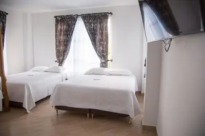 two beds in a room with a window at Beach cabin near Barranquilla in Santa Veronica