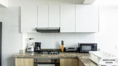 a kitchen with white cabinets and a counter top at Espectacular Duplex con vista al mar in Cartagena de Indias