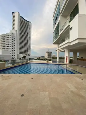 a swimming pool in front of a building with tall buildings at Espectacular Duplex con vista al mar in Cartagena de Indias