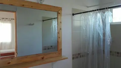 a mirror in a bathroom with a shower at Cabaña 2 en la mejor playa de Coveñas in Coveñas